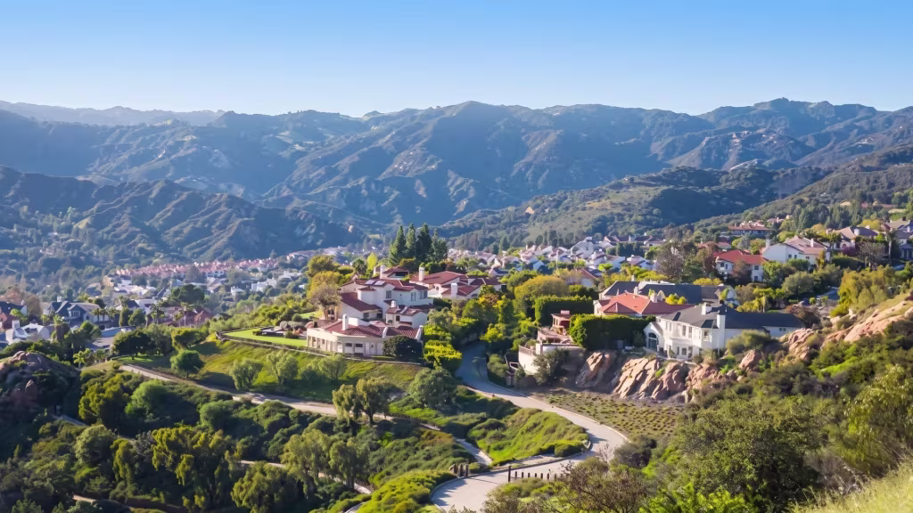 Hillside homes in Agoura Hills trace a broad canyon landscape in this elevated oblique panoramic view