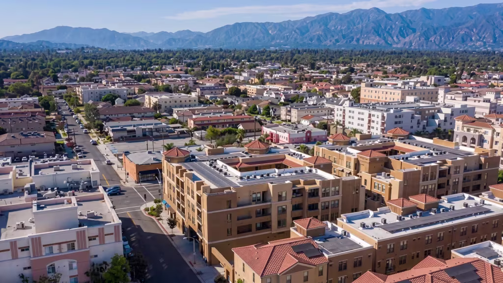 Downtown Alhambra's blocks stretch toward distant mountains in this high aerial oblique city view