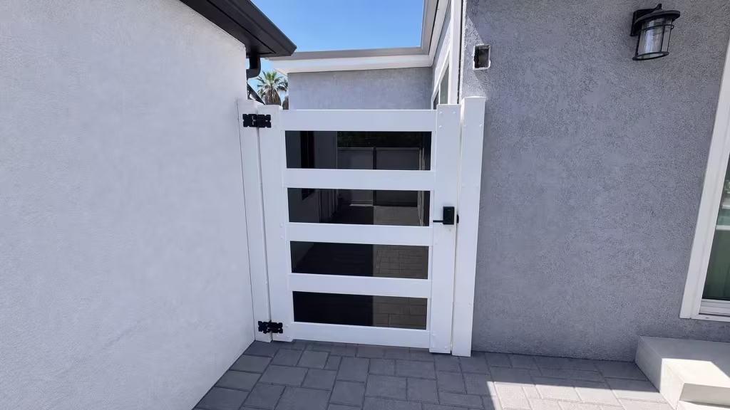 This Arleta side yard now has a White vinyl privacy gate, its acrylic accent openings set beside a sliding glass door