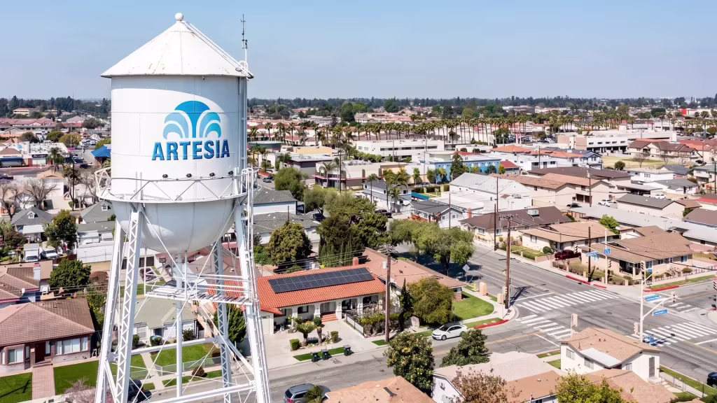 A water-tower landmark rises above Artesia's low-rise neighborhood in this high aerial view