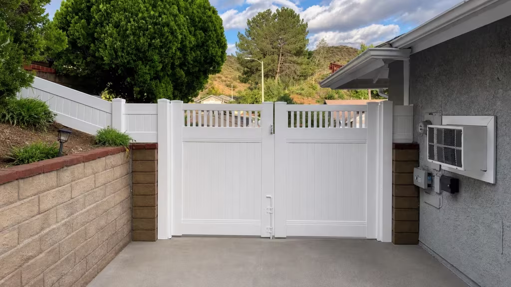 White vinyl privacy fence gate in Santa Clarita pairs solid tongue and groove boards below an open picket band up top