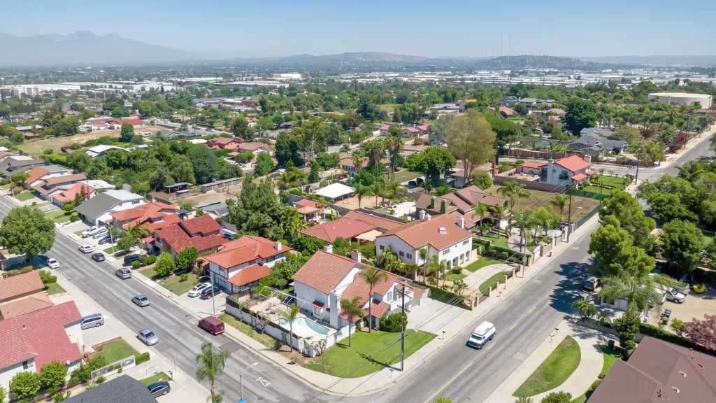 Avocado Heights lays out suburban homes and a street grid beneath distant mountains in this aerial view
