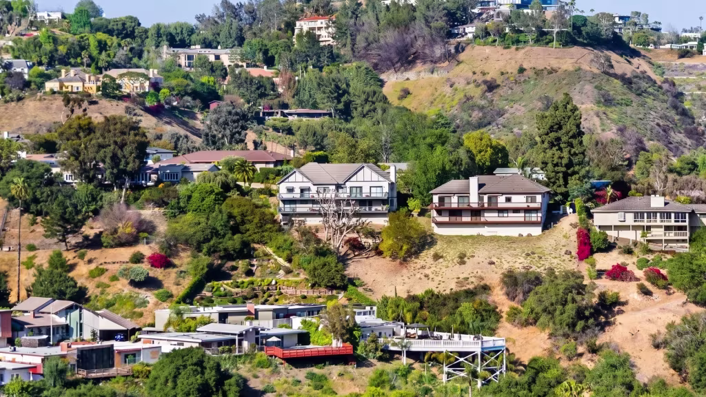 Hillside estates climb wooded slopes above Bel Air in this elevated oblique panoramic view