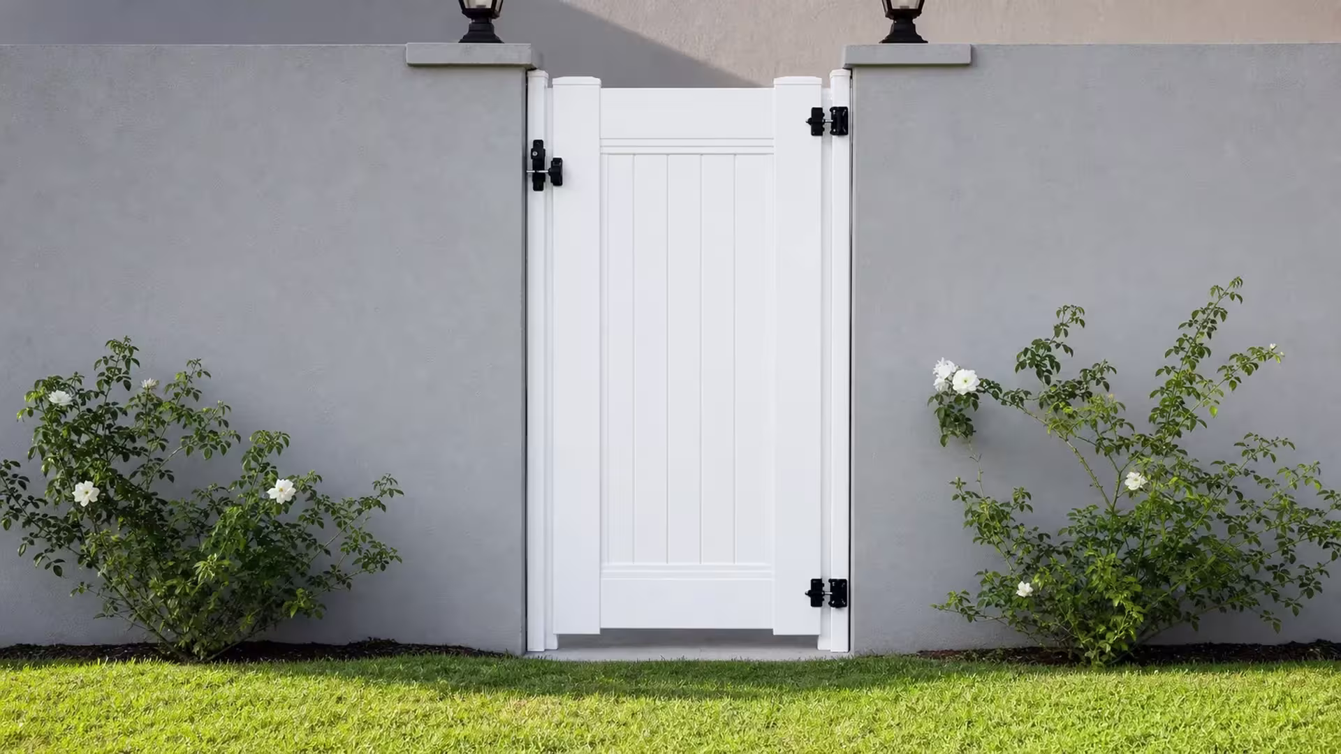 This single White vinyl gate closes an opening in the privacy fence between two gray stucco walls in North Hollywood