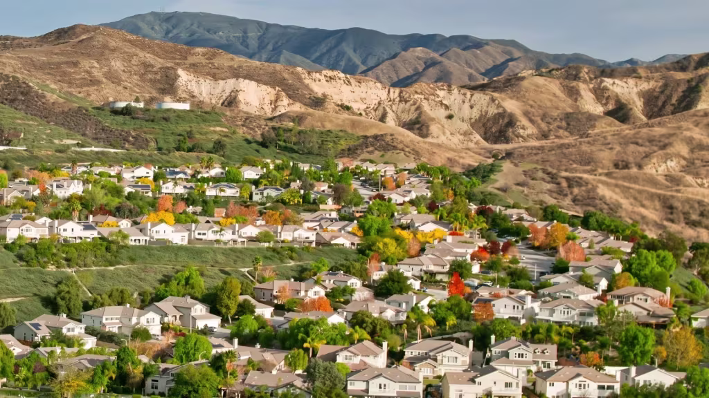 A planned residential community in Canyon Country sits below rugged hills in this elevated oblique view