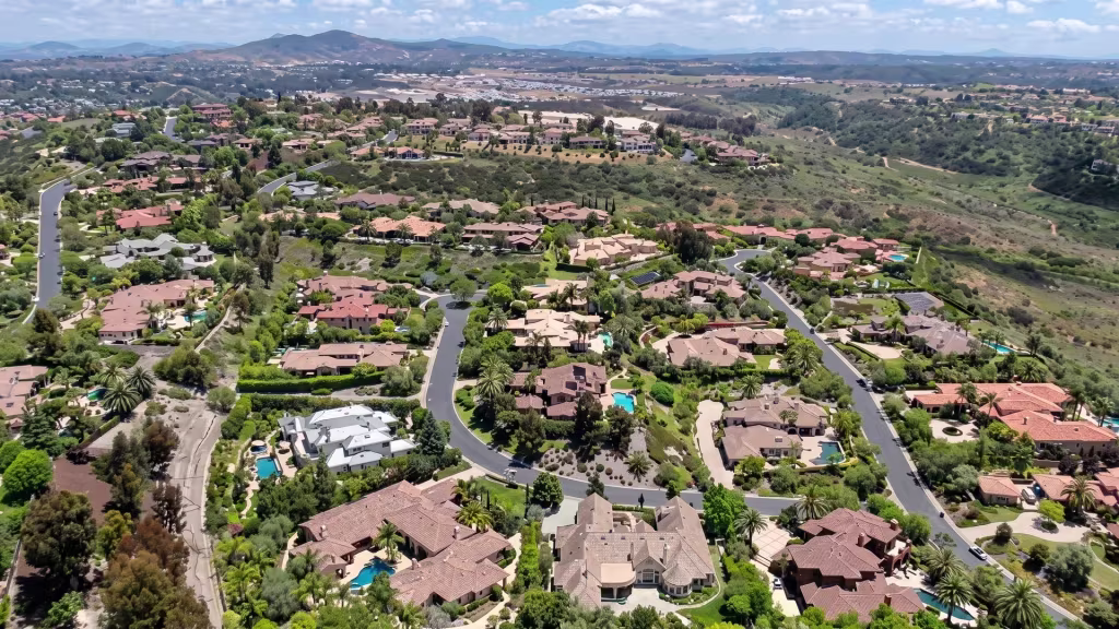 Hillside neighborhoods and winding roads climb across Castro Valley in this aerial panorama