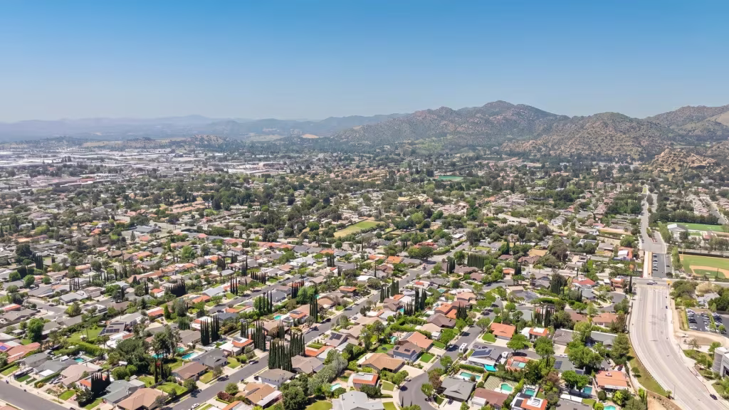 A broad suburban valley stretches beneath rocky hills in this high aerial view over Chatsworth