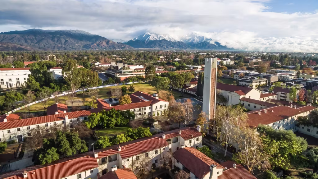 Claremont's college and civic buildings sit beneath snow-capped peaks in this high aerial city view