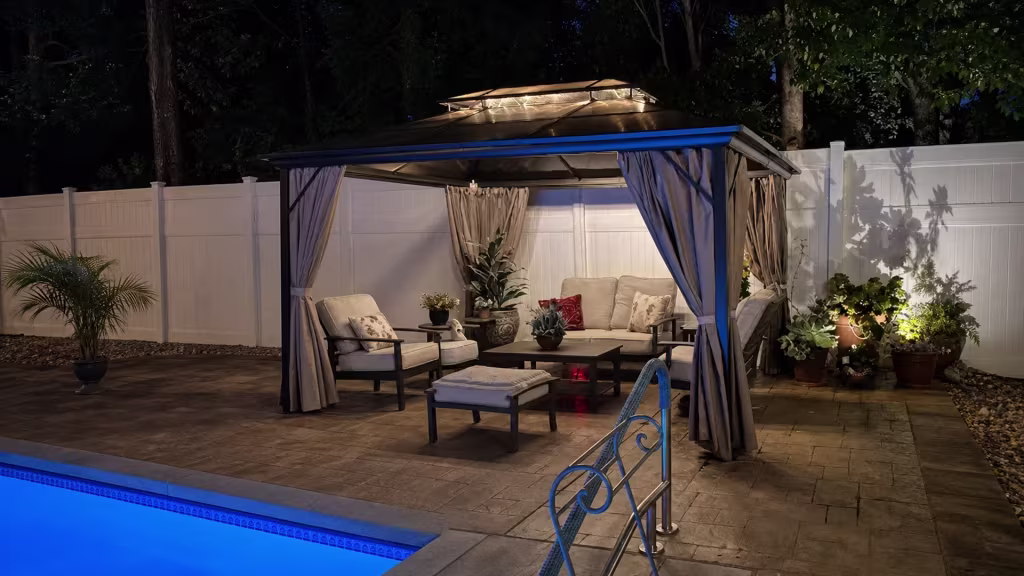 White vinyl privacy fence traces the edge of a poolside patio in Studio City