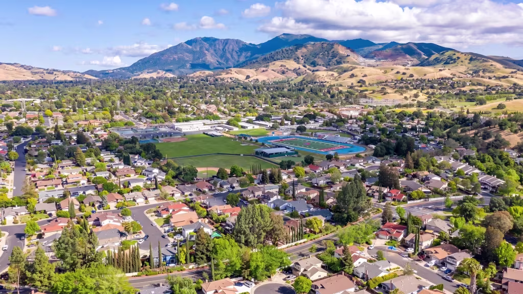 Hills rise behind Concord's suburban neighborhoods in this elevated panoramic view