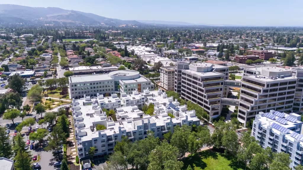 Cupertino's modern offices and homes sit wrapped in greenery, seen from this aerial city view
