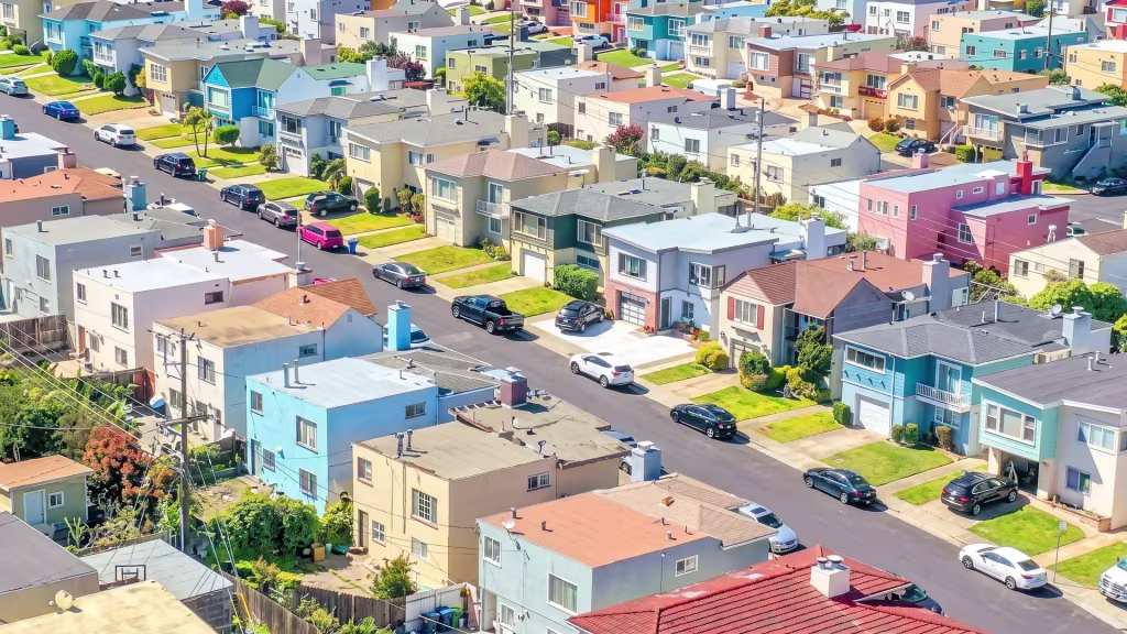 Dense, colorful residential blocks climb the sloping streets of Daly City in this aerial view