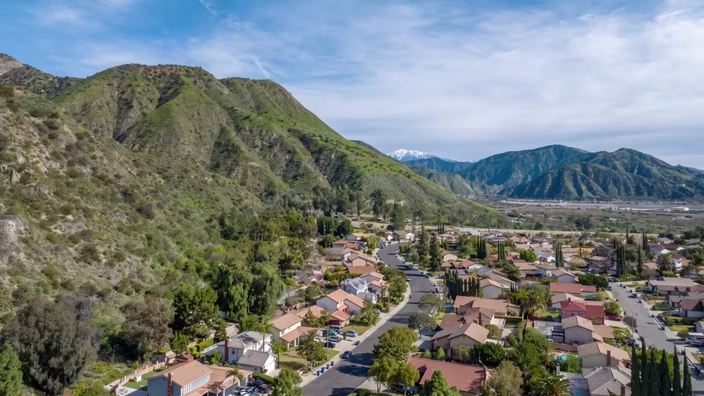 Duarte's homes sit at the base of steep foothills, captured in this elevated panoramic frame