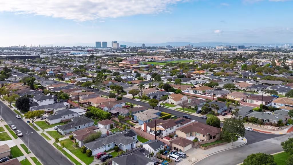 Low-rise neighborhoods spread across Hawthorne with a distant skyline rising on the horizon