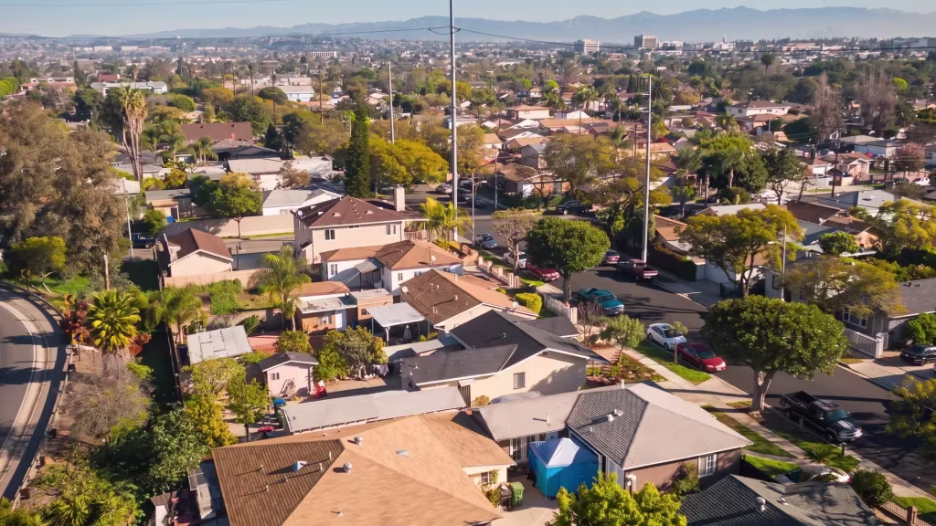 Residential neighborhoods fill Inglewood beneath an urban horizon in this high aerial oblique panorama