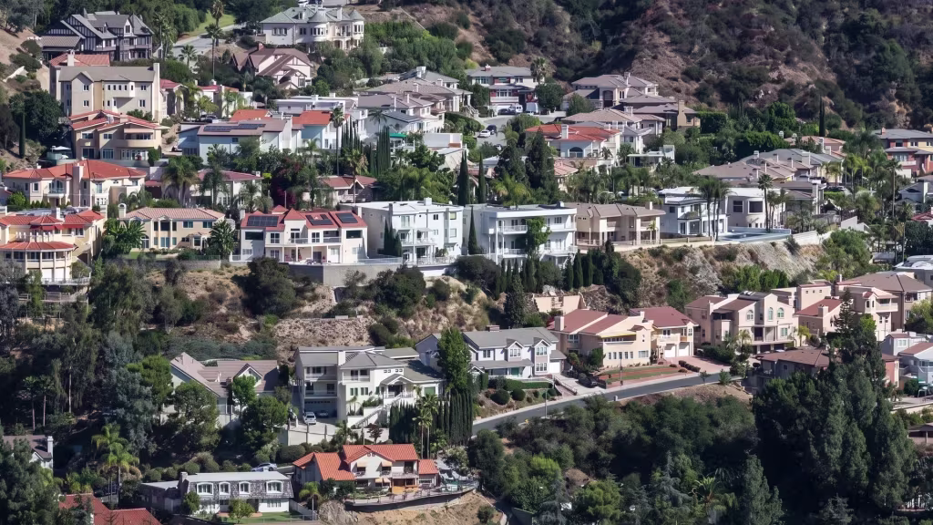 Hillside homes in La Crescenta fill the mountain foothills, captured from a high aerial oblique angle