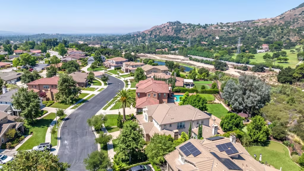 Green slopes surround a planned hillside residential neighborhood in La Verne in this aerial oblique frame