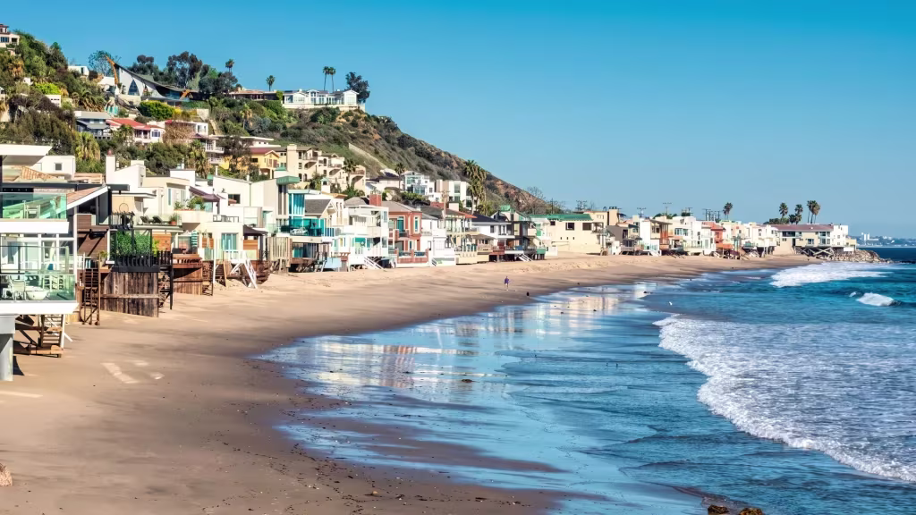 Shoreline homes and coastal bluffs frame a sandy beach along the Malibu coast in this overlook