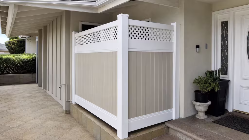 A dark doorbell and glass sidelight flank the entry door beside this Tan and White vinyl fence with a lattice top in Glendale