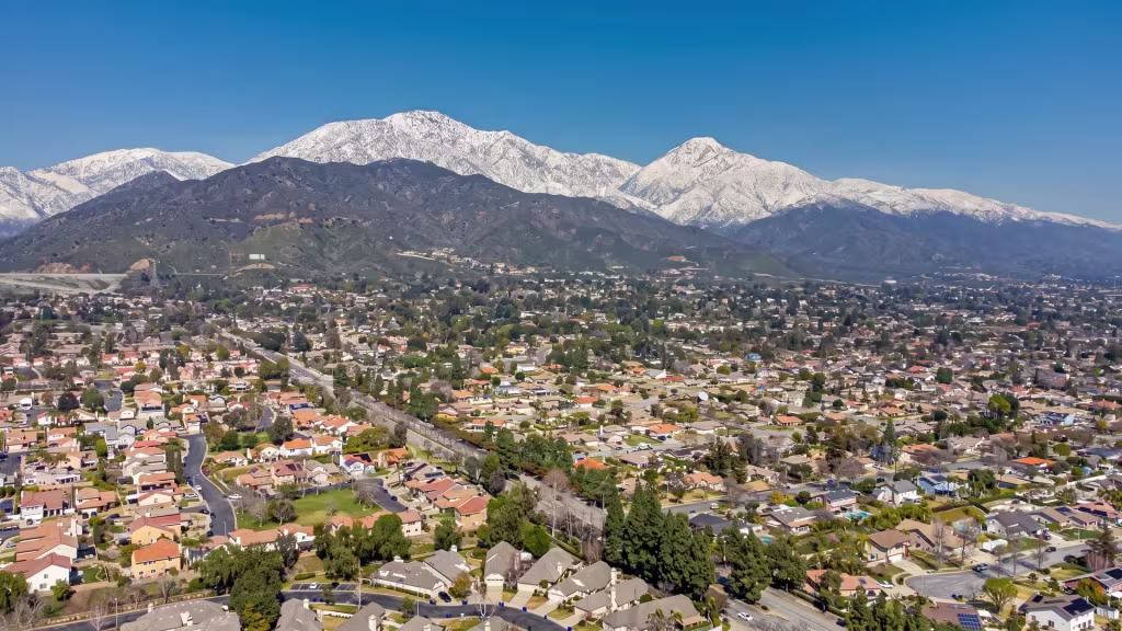 Elevated view over Montclair, a suburban city set beneath a dramatic mountain backdrop