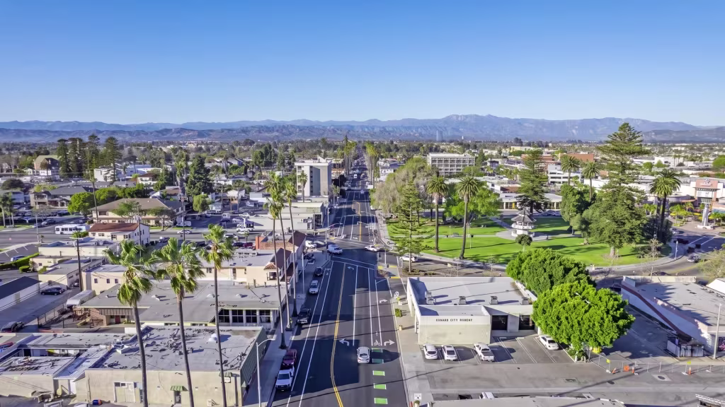 A palm-lined arterial runs through Oxnard in this elevated view over the coastal city