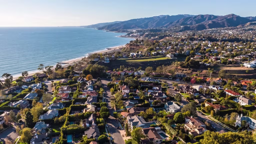 Coastal panorama over Pacific Palisades, taking in the coastline, ocean, and hillside neighborhoods