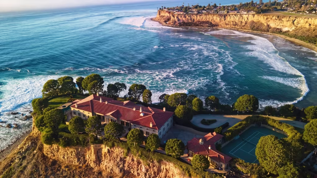 Ocean cliffs and a landscaped estate define this aerial coastal view over Palos Verdes Peninsula