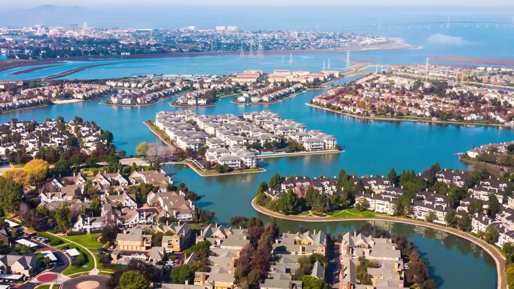 Homes ring the lagoons of Redwood City, with open bay water stretching out just past the last houses