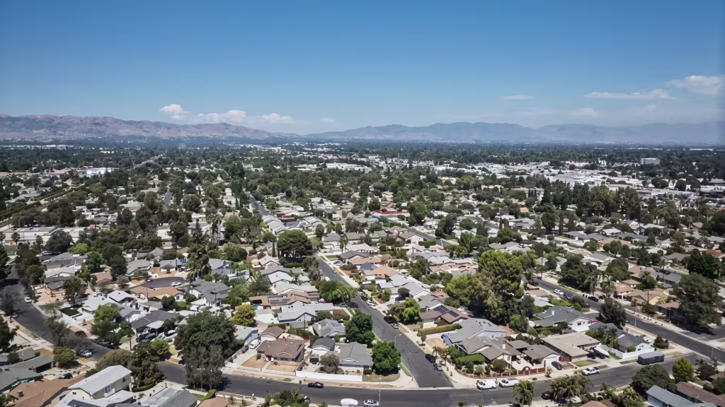 A wide aerial panorama across Reseda shows the suburban valley stretching to the horizon