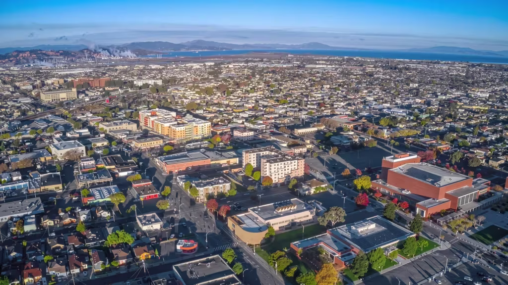 Dense urban neighborhoods in Richmond stretch toward the bay in this aerial panorama