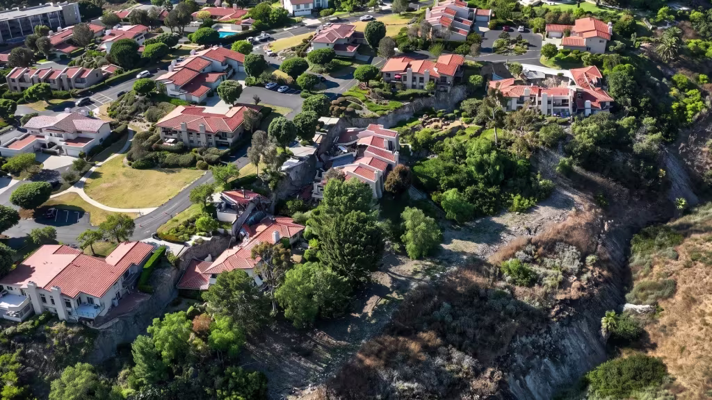 Wooded slopes surround the hillside homes of Rolling Hills in this aerial view