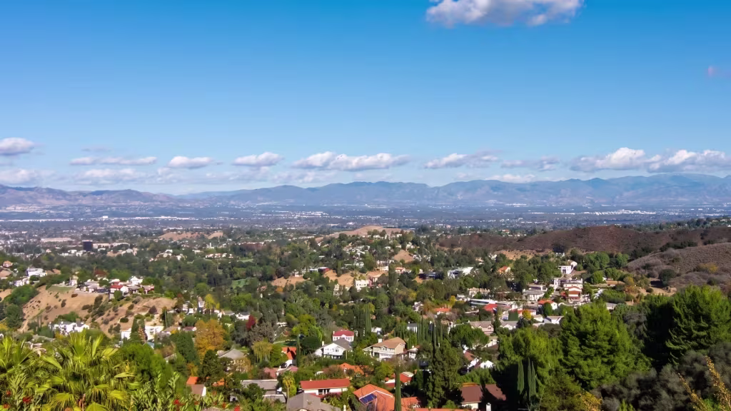 San Fernando's broad hillside panorama unfolds beneath mountains in this elevated view