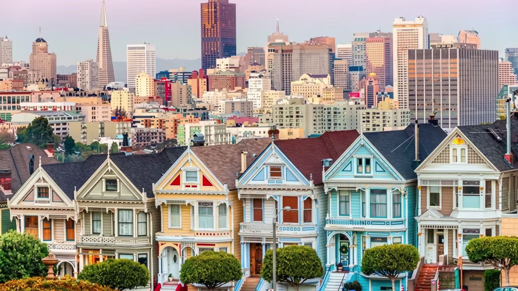 Rows of classic houses stand before the downtown skyline in this elevated view over San Francisco