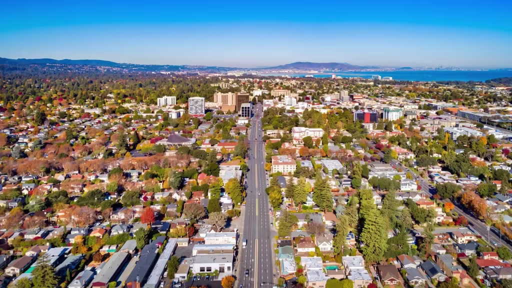 San Mateo's dense residential grid extends toward the bay, where a distant skyline sits on the horizon