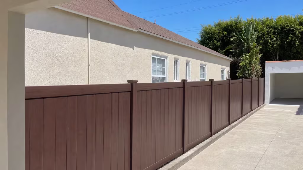Dark Sequoia vinyl privacy fence replacing chain-link and lattice screening along a Los Angeles side yard
