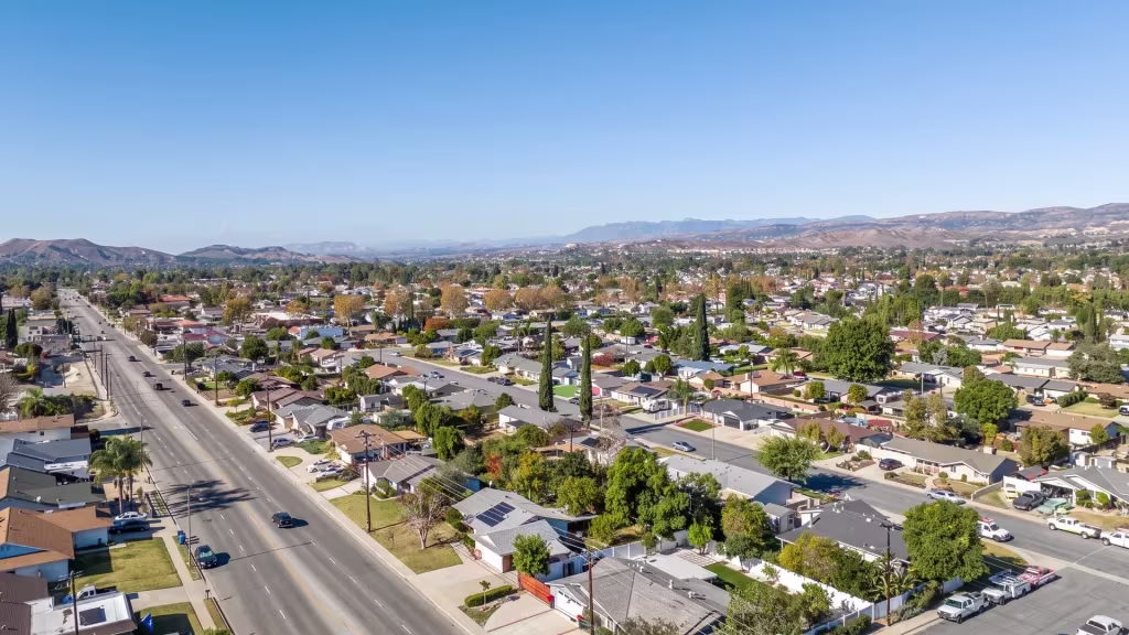 Aerial view over Simi Valley, where a broad suburban avenue runs the length of the valley floor