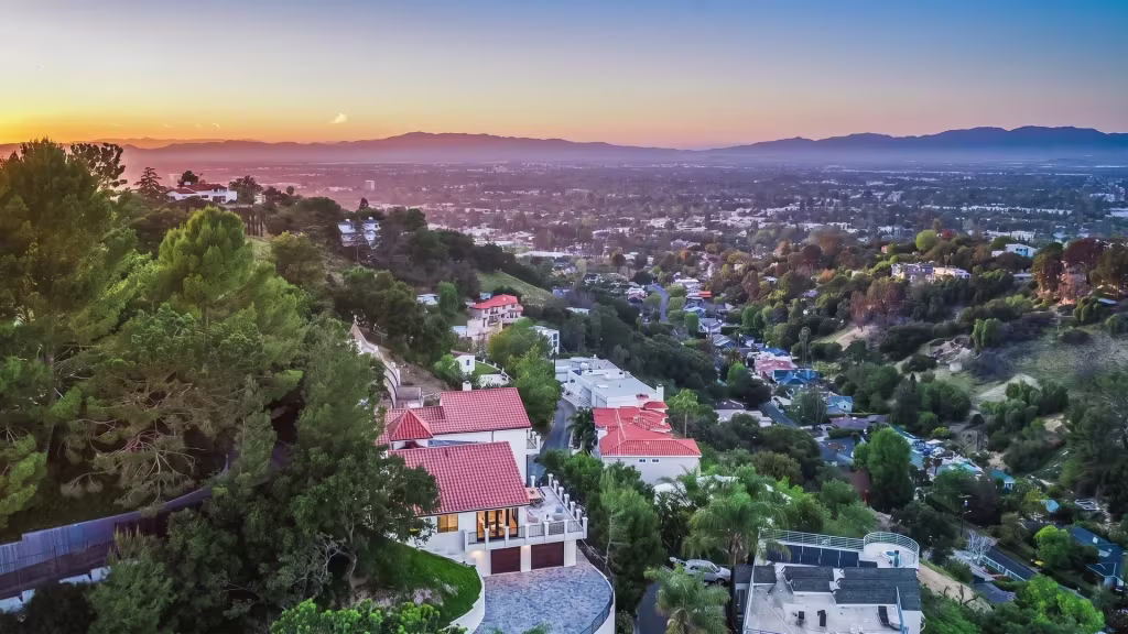 Hillside homes above Studio City overlook the city basin at sunset in this elevated panorama