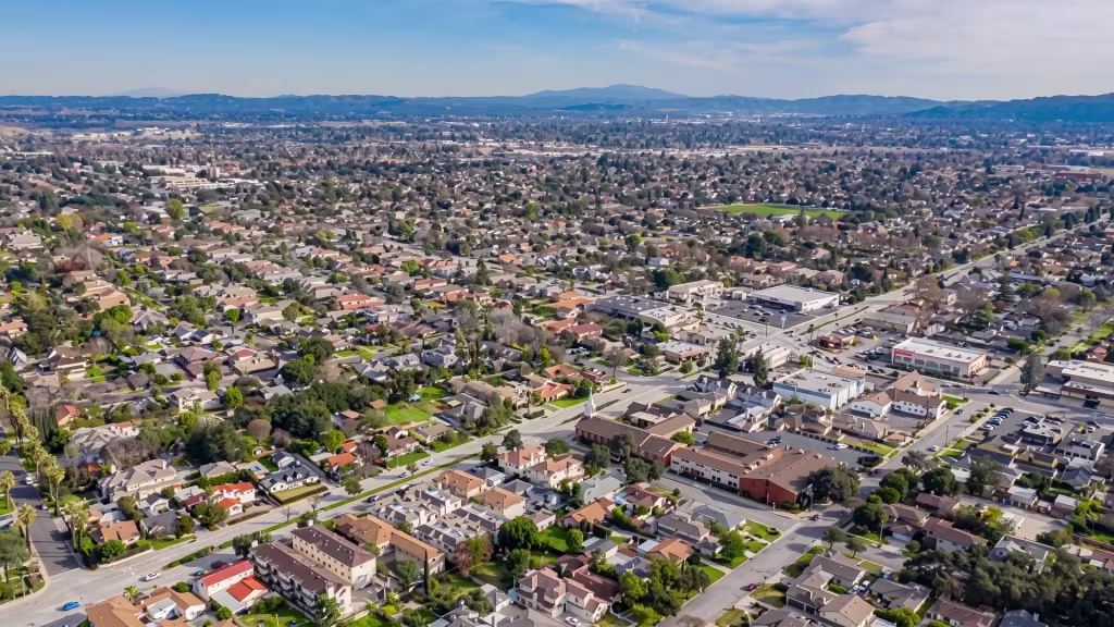 Aerial panorama over Temple City, a broad residential grid laid out beneath nearby foothills