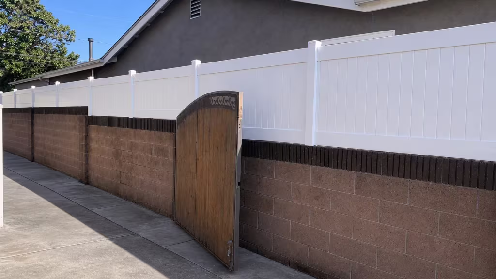 White vinyl privacy wall topper following the grade of the block wall it caps in Lakewood
