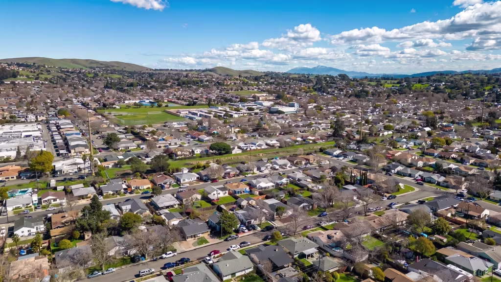 Hillside neighborhoods spread across rolling terrain in this aerial panorama of Vallejo