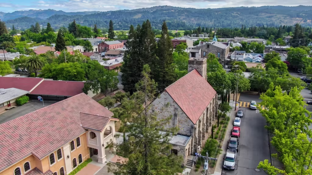 Elevated landmark view over Valley Village, a church landmark set within a tree-lined residential district