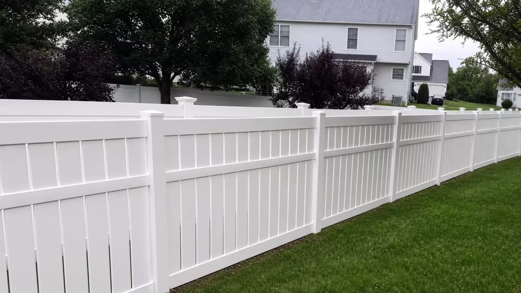 White vinyl fence pairs solid lower boards with an open picket band beside a two-story neighboring house