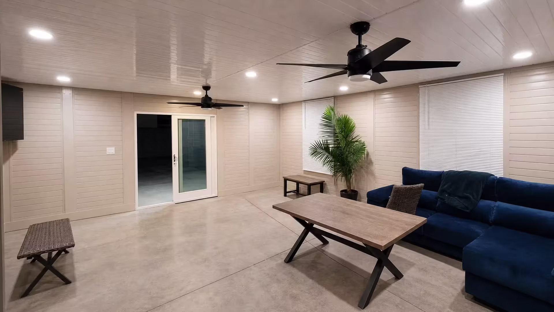Horizontal wall panels wrap every side of this custom-designed patio cover in White vinyl, beneath a matching paneled ceiling