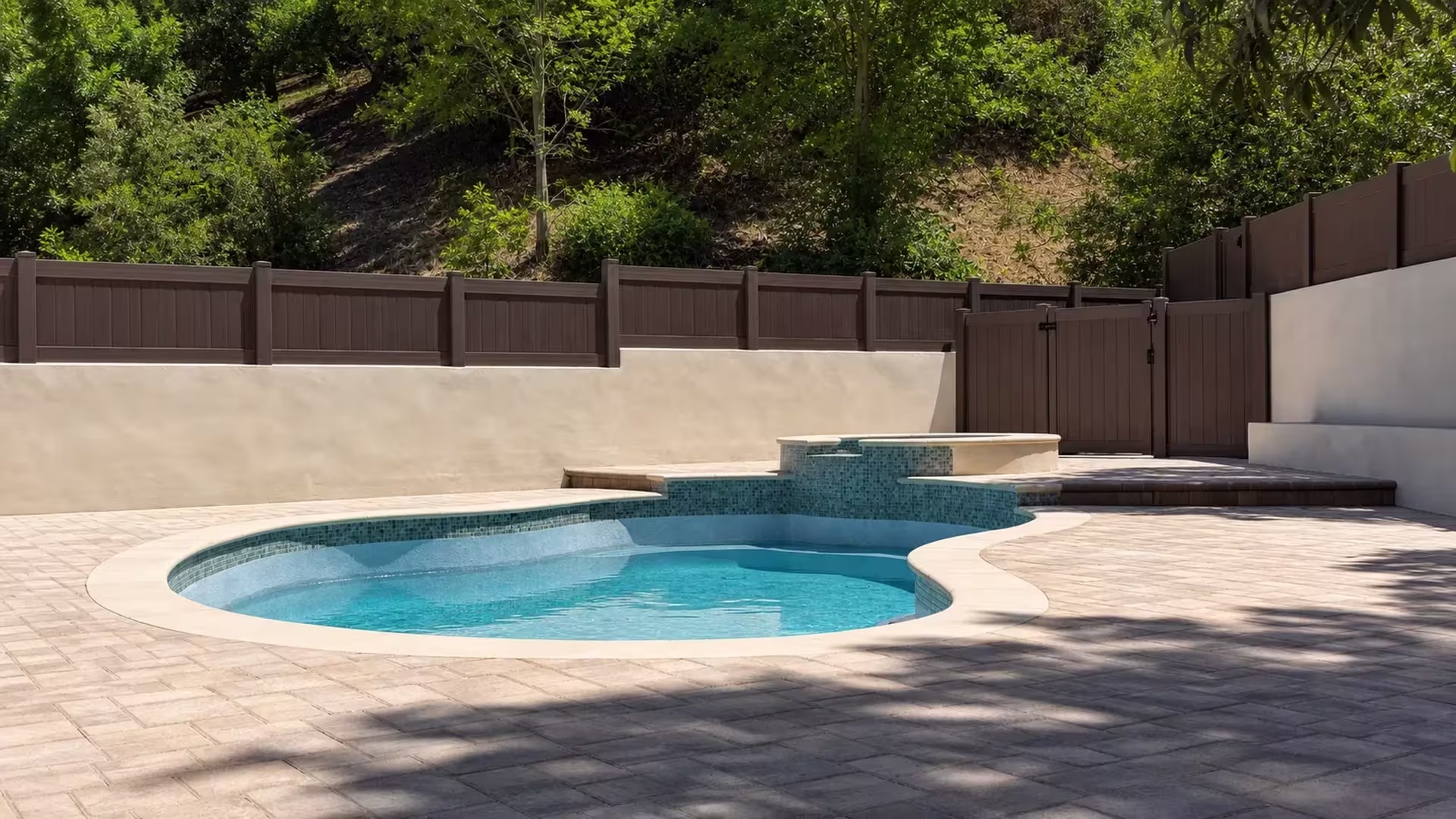 Dark Walnut vinyl wall topper, built custom, set against a stucco wall behind a pool with a raised tiled spa