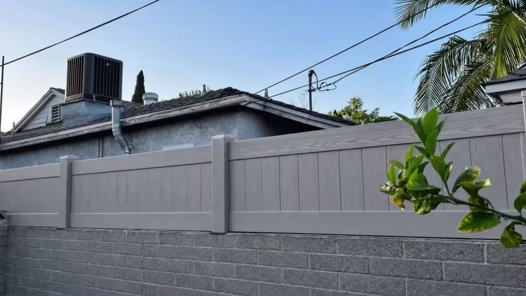 Mesquite custom vinyl wall topper with a woodgrain finish installed continuously atop a gray concrete block wall