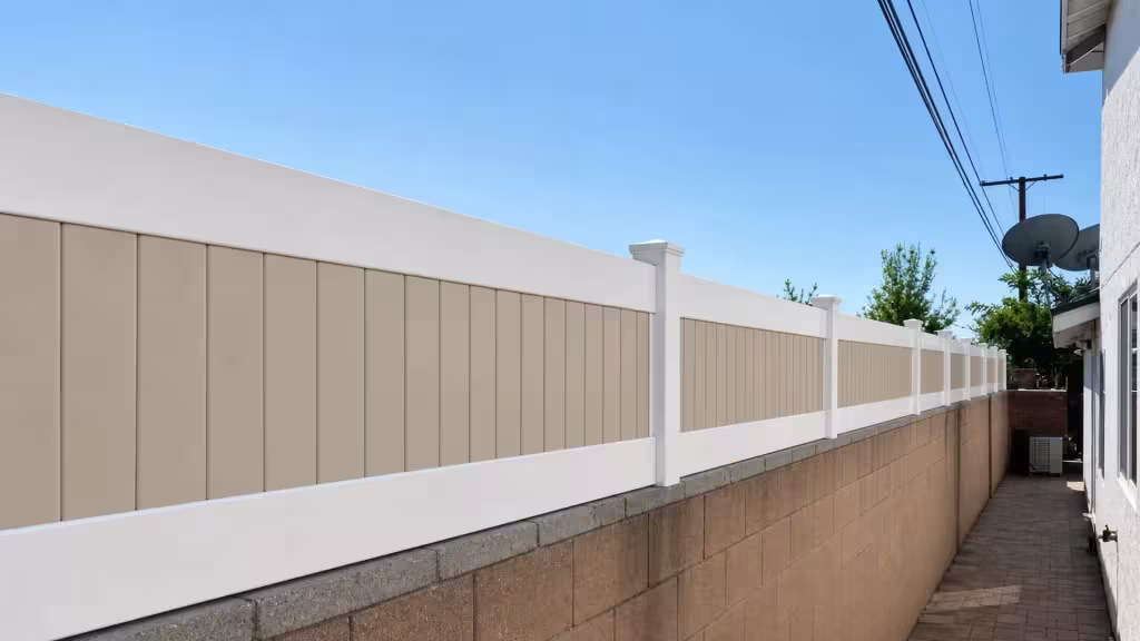 White and Tan custom vinyl wall topper lining a narrow paved side yard beneath overhead utility wires