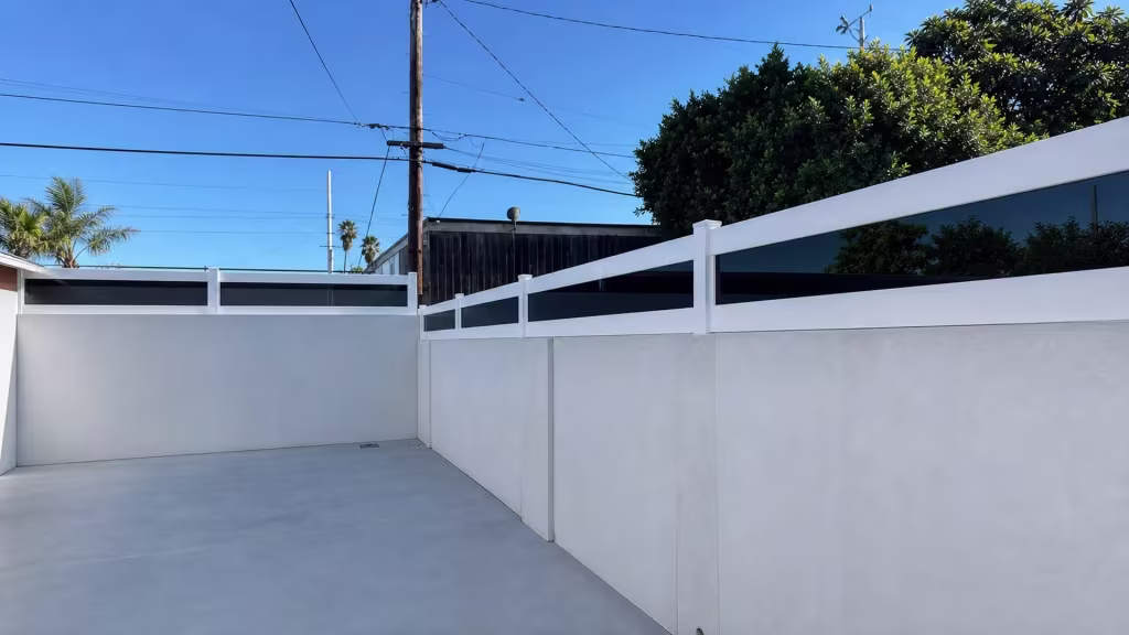 Three acrylic bays step diagonally through a White custom vinyl wall topper beside a neighboring dark fence
