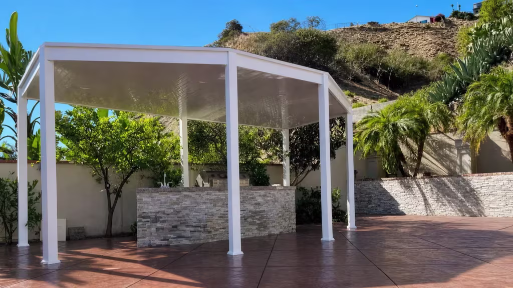 Freestanding White vinyl patio cover spans a backyard beneath a broad nearly flat solid roof plane