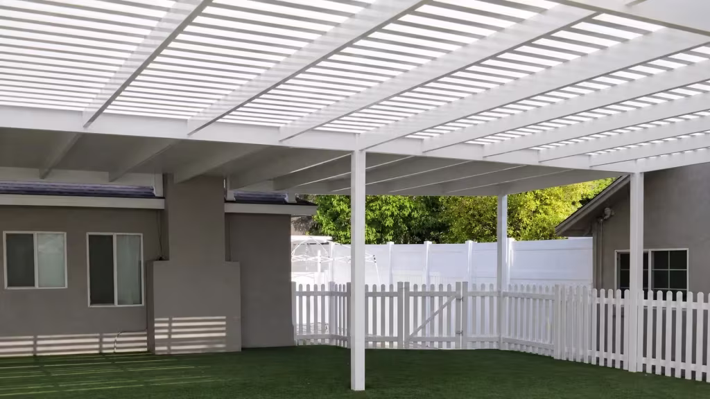 White vinyl picket patio cover filled with dense, evenly spaced overhead shade slats