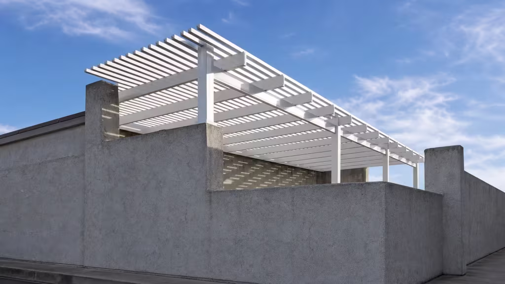 Existing masonry wall and pier frame a White vinyl lattice pergola-style picket patio cover behind the property